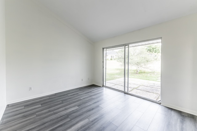 spare room with lofted ceiling and dark hardwood / wood-style floors