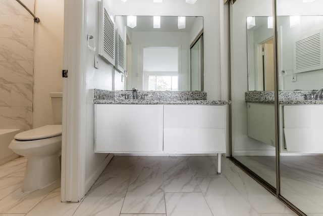 bathroom with vanity, toilet, and walk in shower