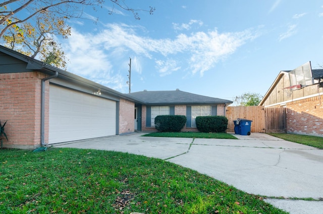 ranch-style house featuring a garage and a front yard