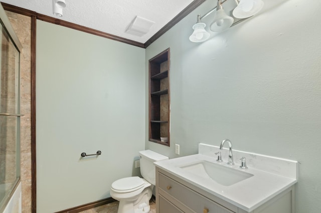 bathroom featuring vanity, a textured ceiling, toilet, and ornamental molding