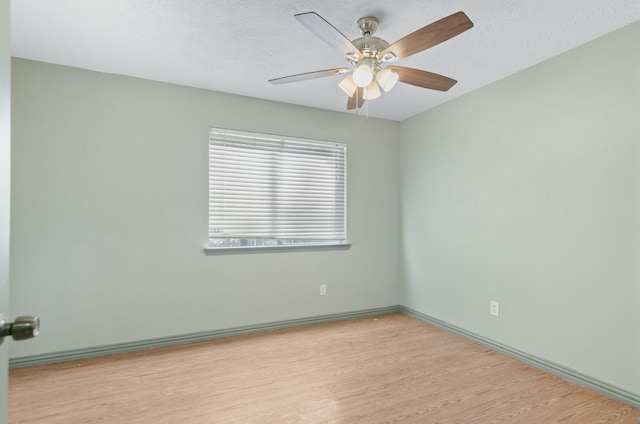 unfurnished room with ceiling fan, light hardwood / wood-style floors, and a textured ceiling