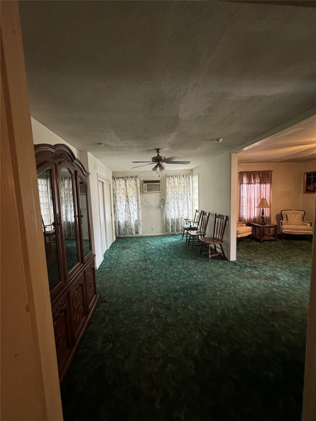 interior space featuring carpet flooring, an AC wall unit, and ceiling fan