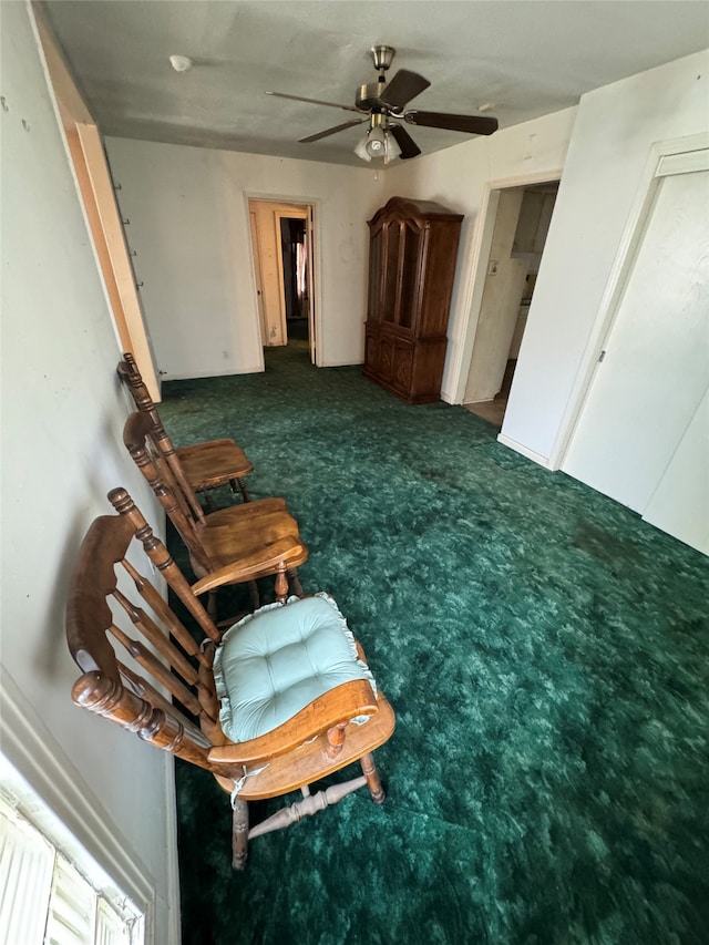 unfurnished room featuring ceiling fan and dark carpet