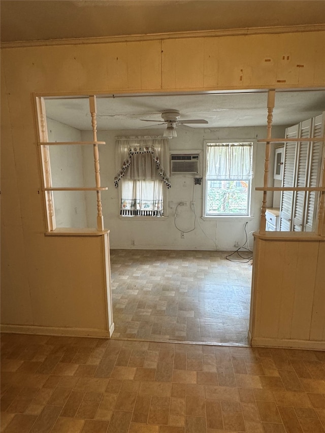 empty room featuring an AC wall unit and ceiling fan