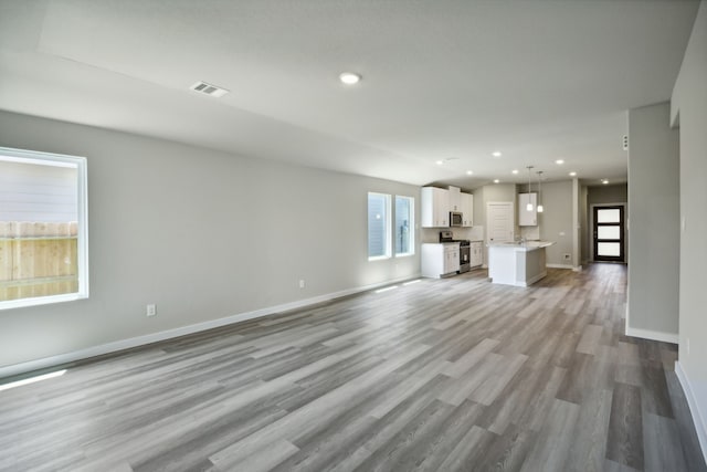 unfurnished living room with light hardwood / wood-style floors