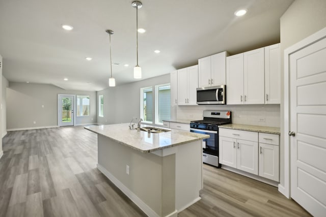 kitchen with pendant lighting, sink, white cabinetry, and appliances with stainless steel finishes