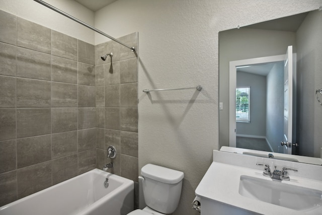 full bathroom with vanity, tiled shower / bath combo, and toilet