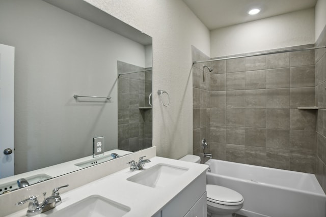 full bathroom featuring vanity, toilet, and tiled shower / bath combo