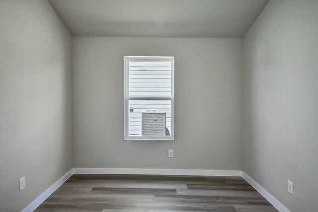 spare room with dark hardwood / wood-style flooring