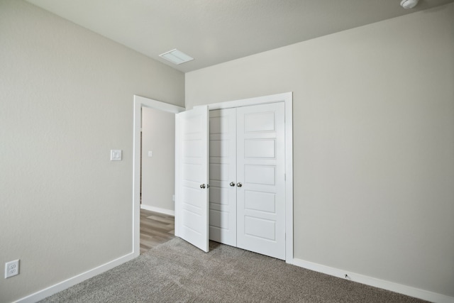 unfurnished bedroom with carpet floors and a closet