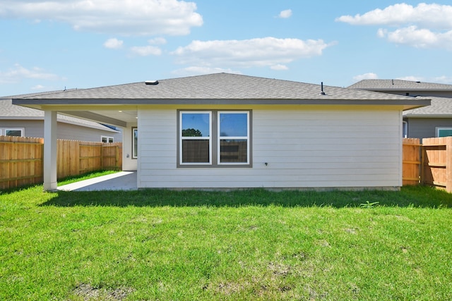 rear view of house featuring a yard and a patio area