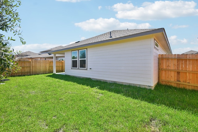 rear view of house featuring a lawn