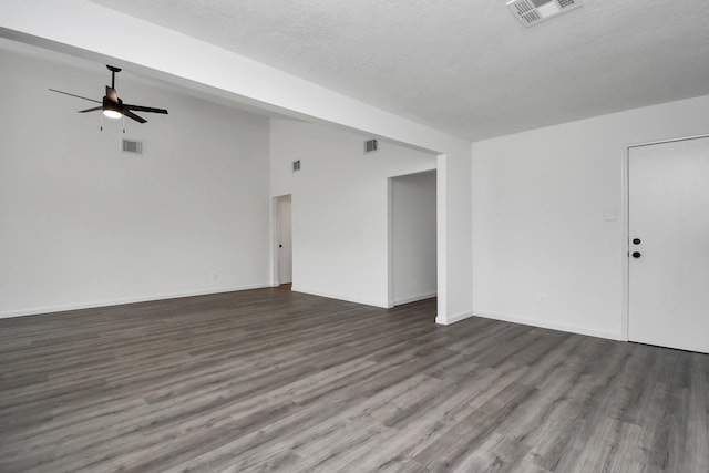 unfurnished room with ceiling fan, a textured ceiling, and dark hardwood / wood-style flooring