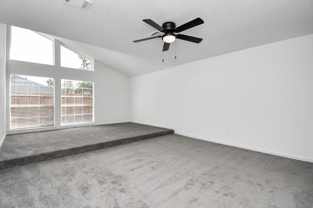 carpeted empty room featuring ceiling fan and vaulted ceiling