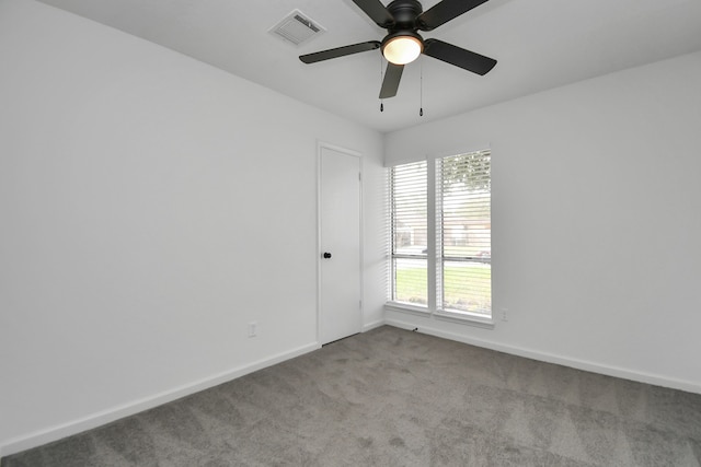 empty room featuring ceiling fan and light colored carpet