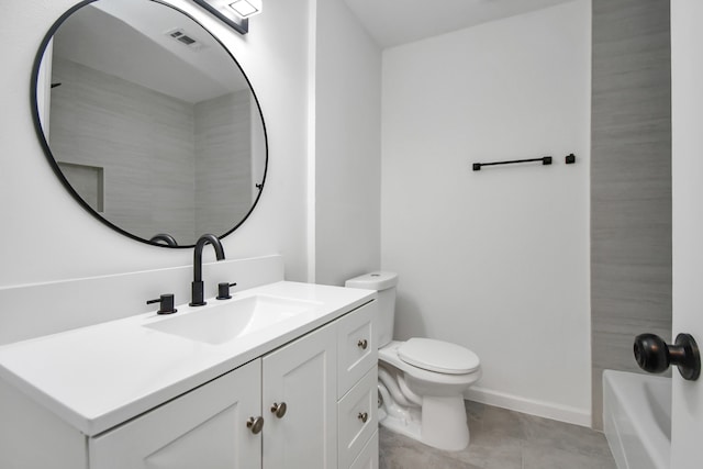 bathroom with toilet, vanity, and tile patterned flooring