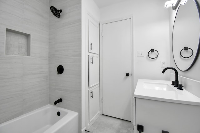 bathroom featuring vanity and tiled shower / bath