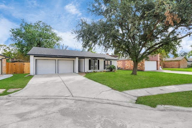 ranch-style house featuring a garage and a front lawn