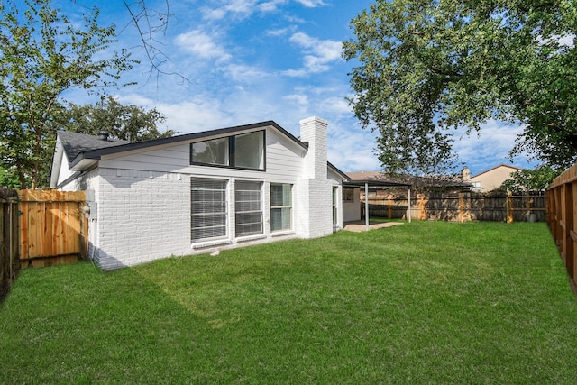 back of house with a lawn