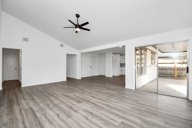 unfurnished living room with hardwood / wood-style floors, ceiling fan, and high vaulted ceiling