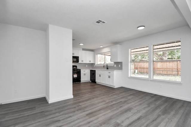 kitchen featuring white cabinets, black appliances, and dark wood-type flooring