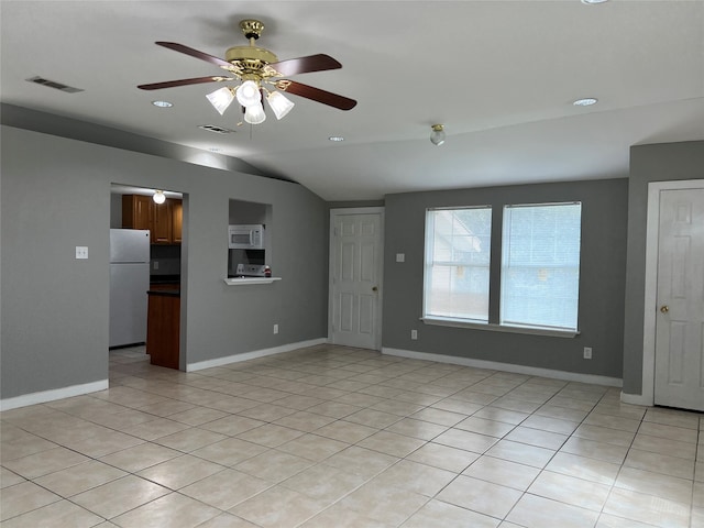 unfurnished living room featuring lofted ceiling, light tile patterned floors, and ceiling fan