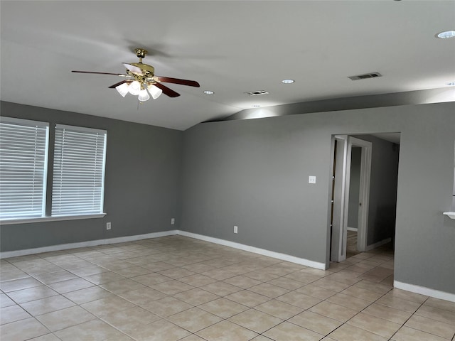 tiled spare room with lofted ceiling and ceiling fan