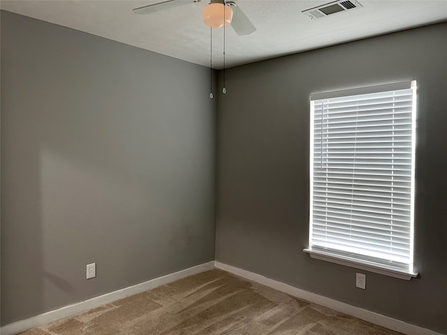 carpeted empty room with ceiling fan