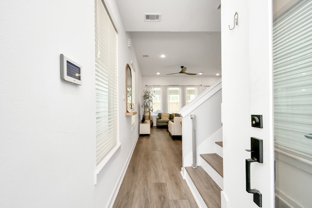 entrance foyer with ceiling fan and light hardwood / wood-style flooring