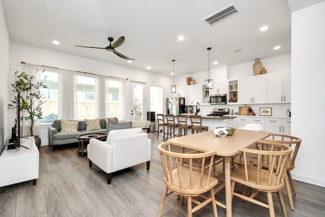 dining room featuring light hardwood / wood-style floors and ceiling fan