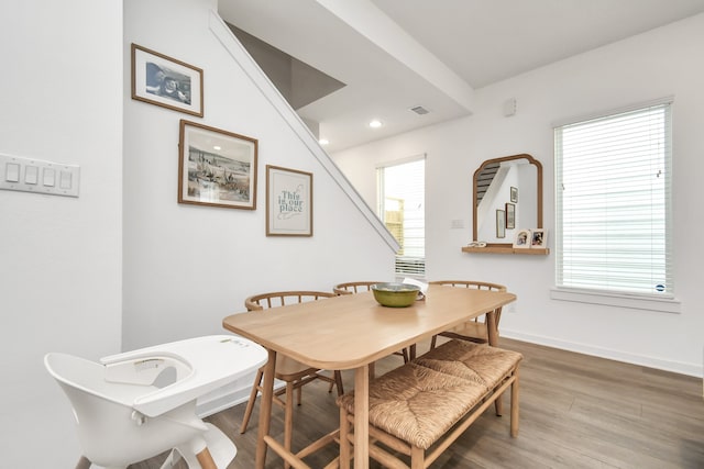 dining area featuring hardwood / wood-style floors and a healthy amount of sunlight