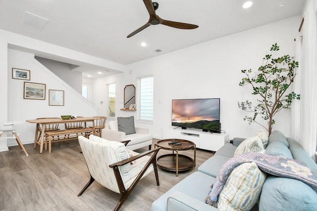 living room with hardwood / wood-style flooring and ceiling fan