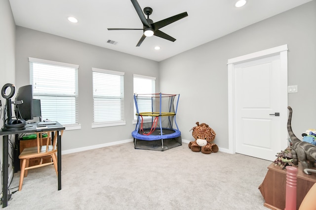 game room featuring light carpet and ceiling fan