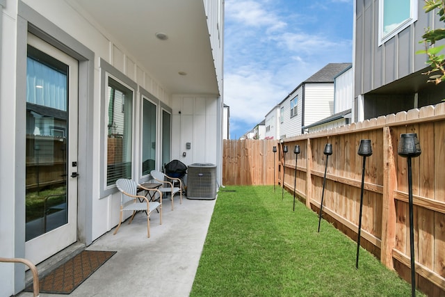 view of yard with cooling unit and a patio area