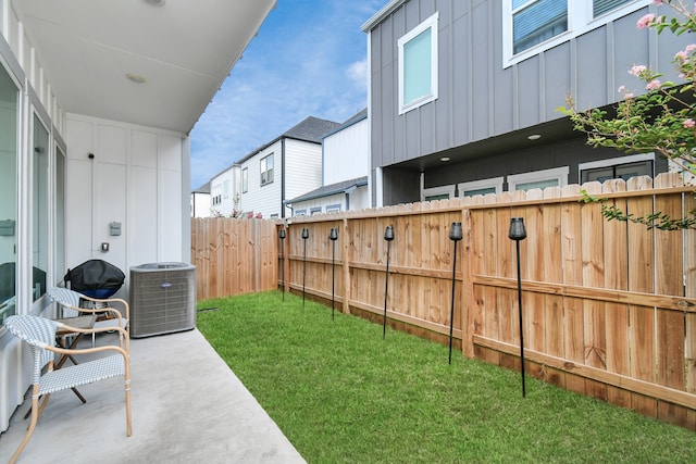 view of yard with cooling unit and a patio area