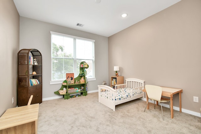 carpeted bedroom with a crib