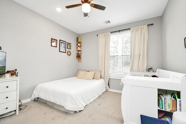 bedroom with light carpet and ceiling fan