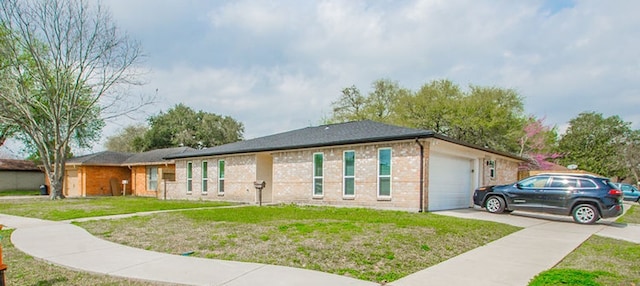 view of front of property with a garage and a front lawn