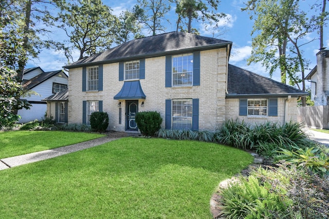 colonial inspired home with a front lawn