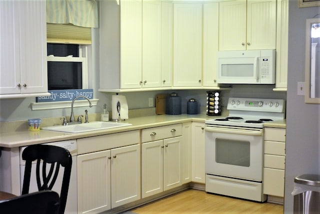 kitchen featuring light hardwood / wood-style floors, white appliances, and sink