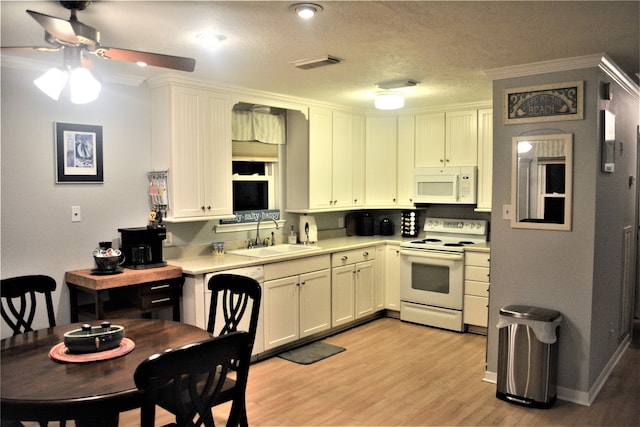 kitchen featuring white appliances, crown molding, sink, light hardwood / wood-style flooring, and white cabinetry