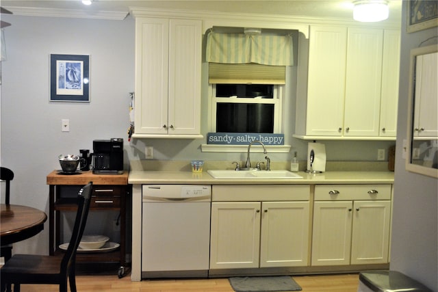 kitchen with ornamental molding, dishwasher, light wood-type flooring, and sink