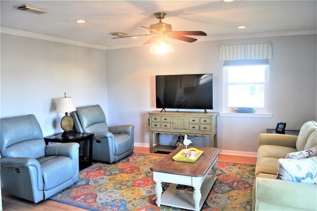 living room with wood-type flooring, ceiling fan, and crown molding