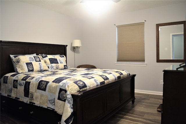 bedroom with dark hardwood / wood-style floors and ceiling fan