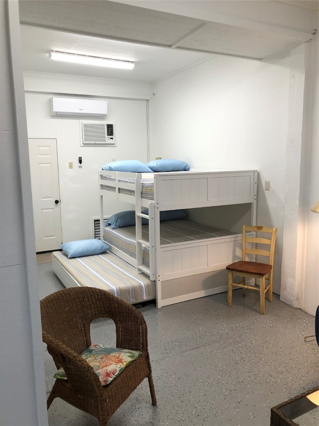 bedroom featuring a wall mounted AC