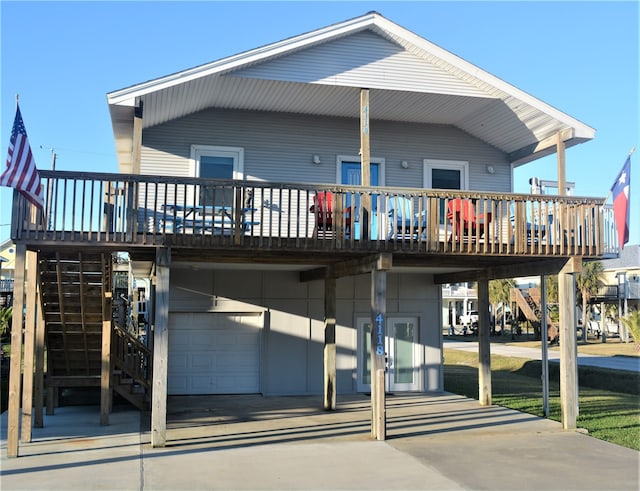 back of property with a garage and a deck