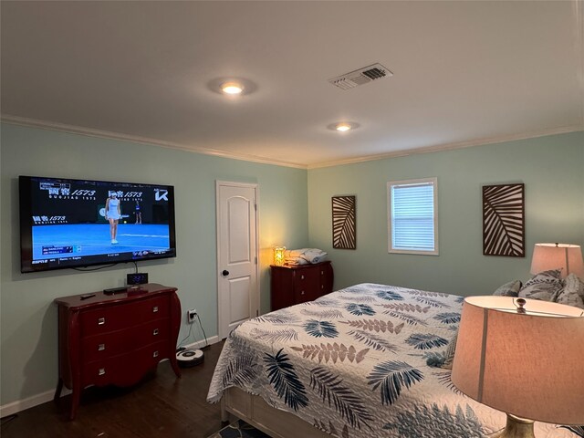 bedroom featuring dark wood-type flooring and ornamental molding