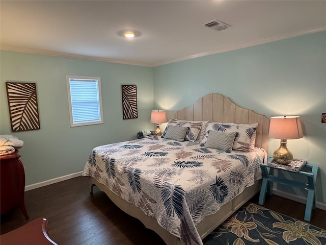 bedroom with dark hardwood / wood-style flooring and ornamental molding