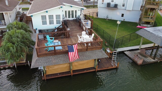 exterior space featuring a yard and a deck with water view