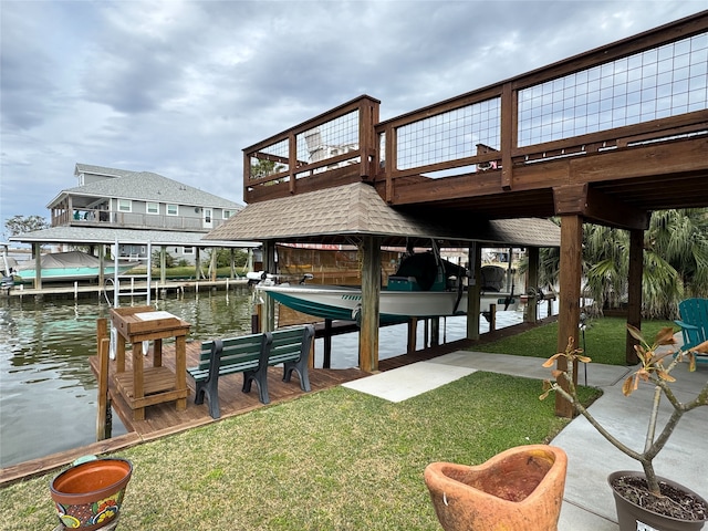 dock area featuring a lawn and a water view